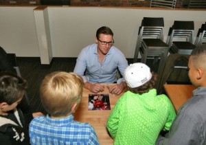 Detroit Red Wings goalie Jimmy Howard signs autographs for fans as part of a charity appearance at Mt. Brighton last week. (Photo: Mark A. Dull)